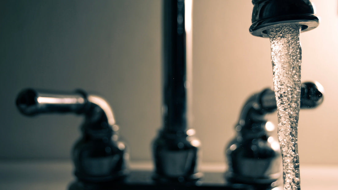 Traditional brass tap running water into a bath
