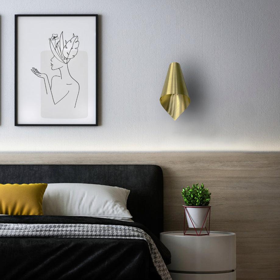 Brass Asymmetric Wall Light Positioned beside a bed