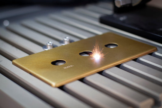 Brass light switch plate being constructed  