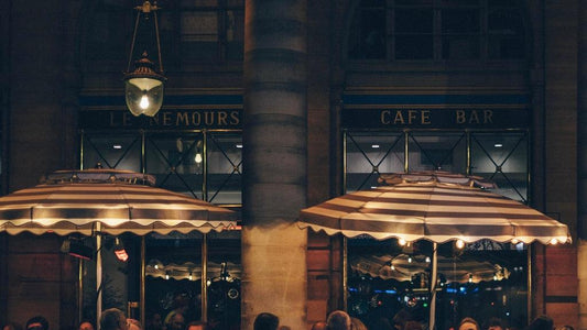 People sat outside a cafe in the evening in france